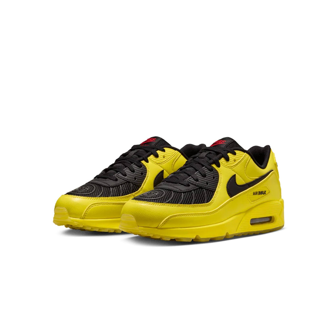 Yellow and black Nike Air Max sneakers with visible Air cushioning and textured panel detailing.