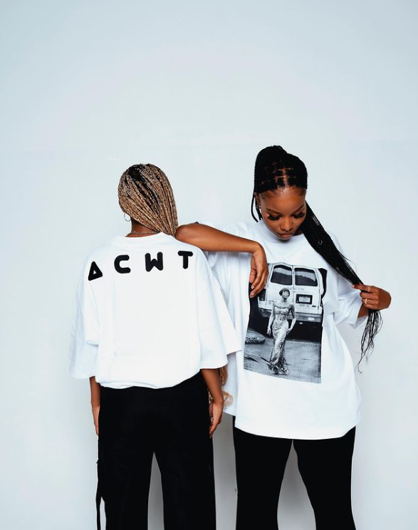 Monochrome outfits showcasing black and white oversized T-shirts with graphic prints paired with black pants in a minimal street style look.