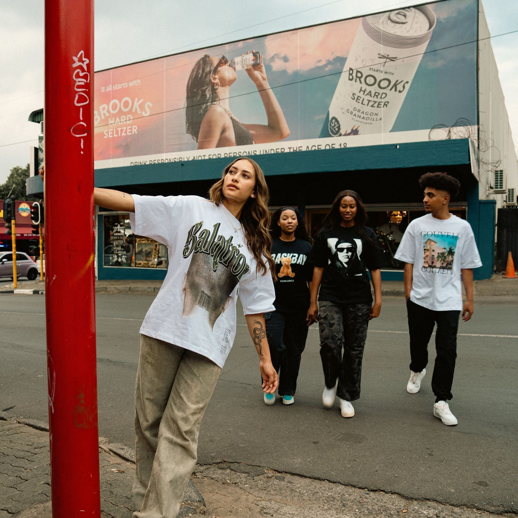 Streetwear models styling oversized graphic T-shirts with relaxed track pants for a modern urban fashion look.