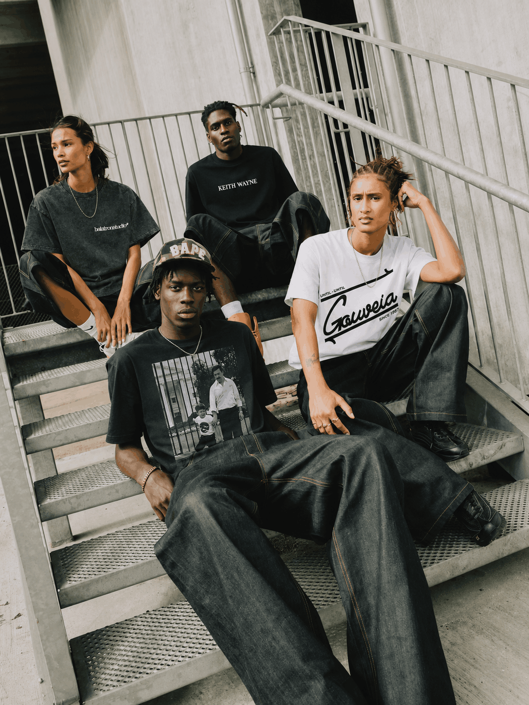 Group wearing relaxed graphic T-shirts, wide-leg trousers and sneakers, offering streetwear inspiration for comfortable airport outfits.