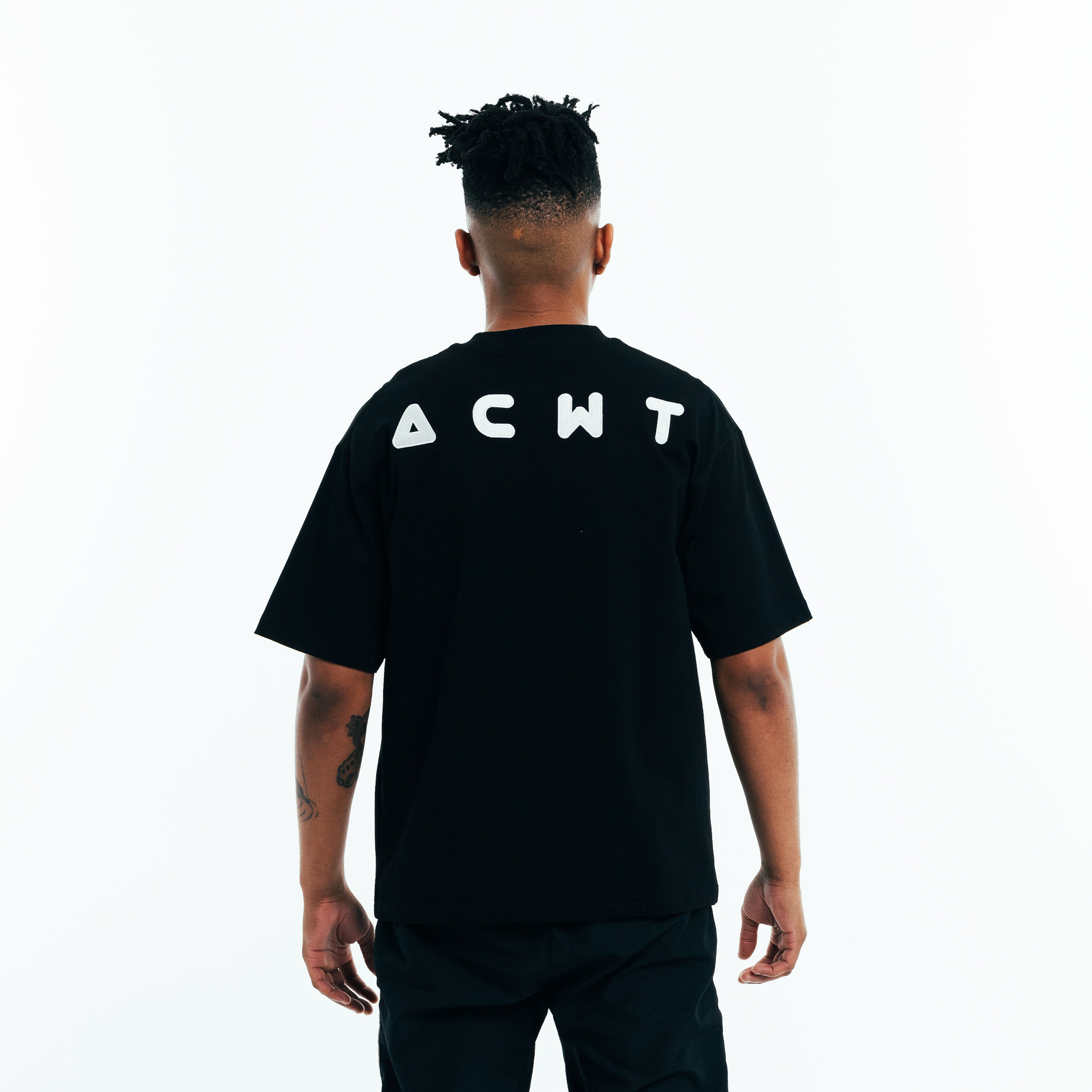 Back view of black t-shirt with logo detail, soft cotton fabric