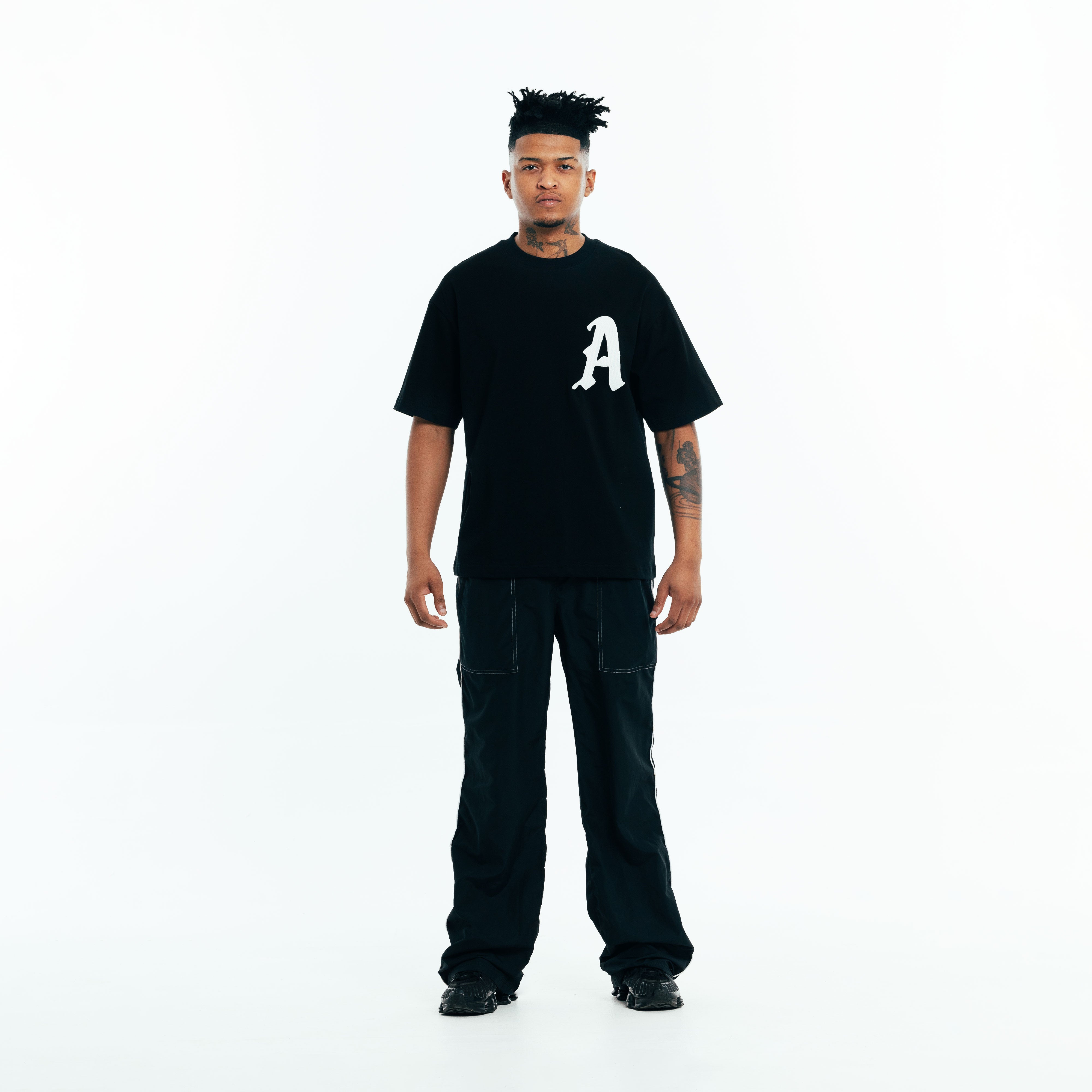 Full outfit with black t-shirt styled in a modern casual look