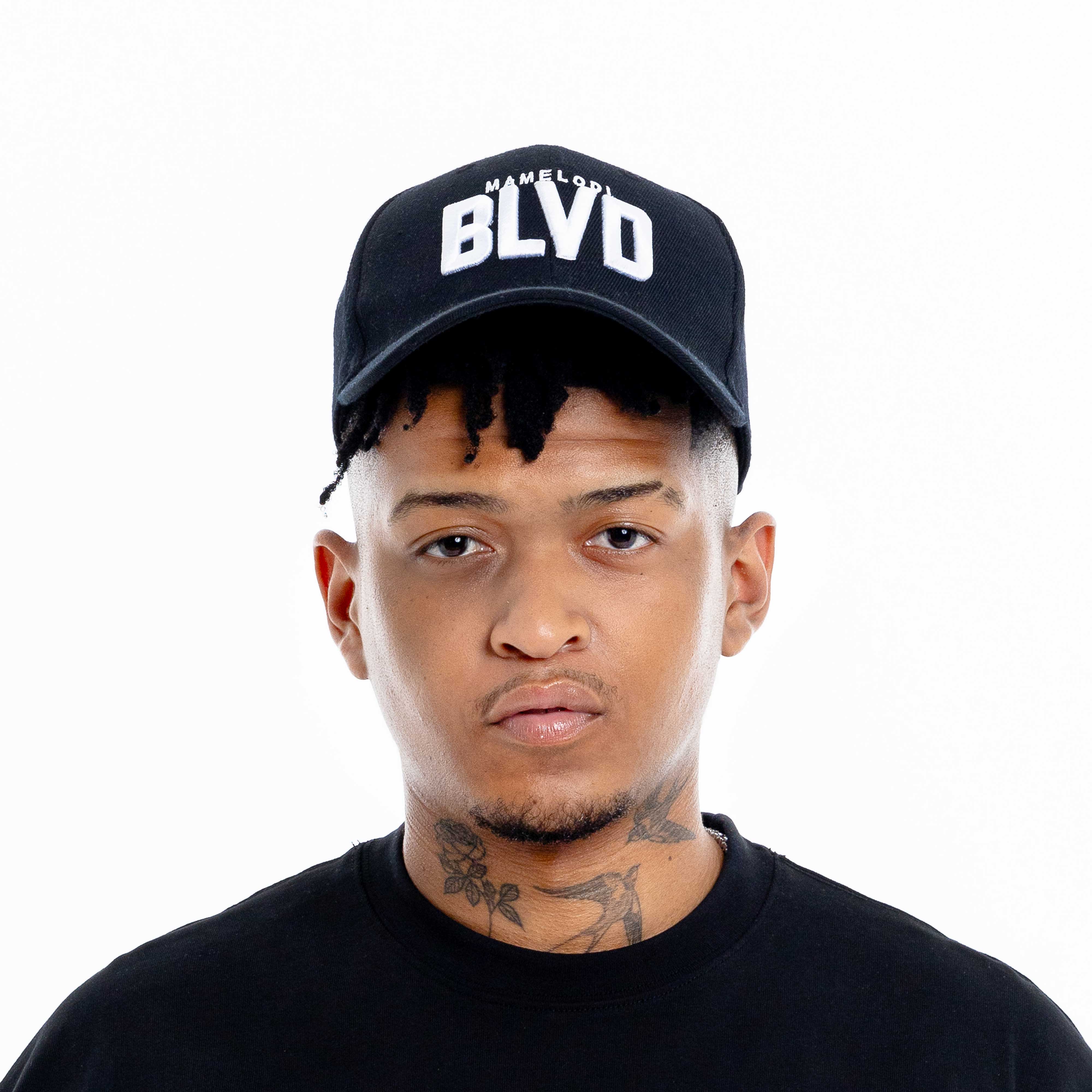Mens black caps worn by model featuring BLVD logo